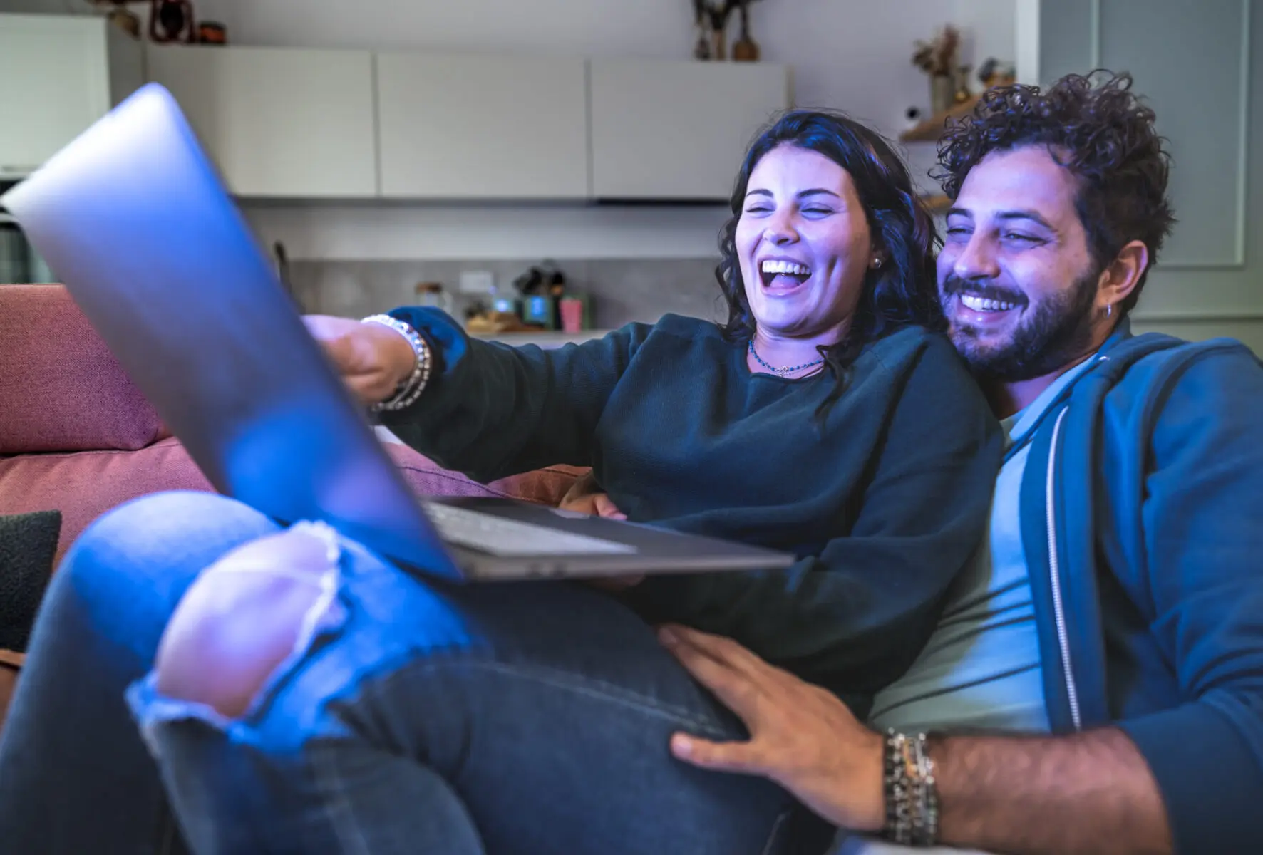 A young couple cuddles on a cozy couch as they search for budget BWT Operadora