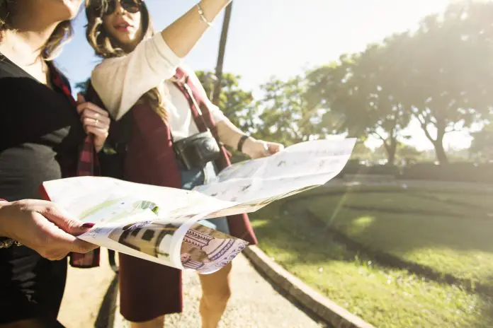 crop-women-with-map-standing-street