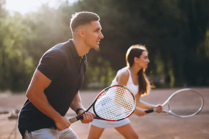 Young couple playing tennis at the court Fairmont beach tennis