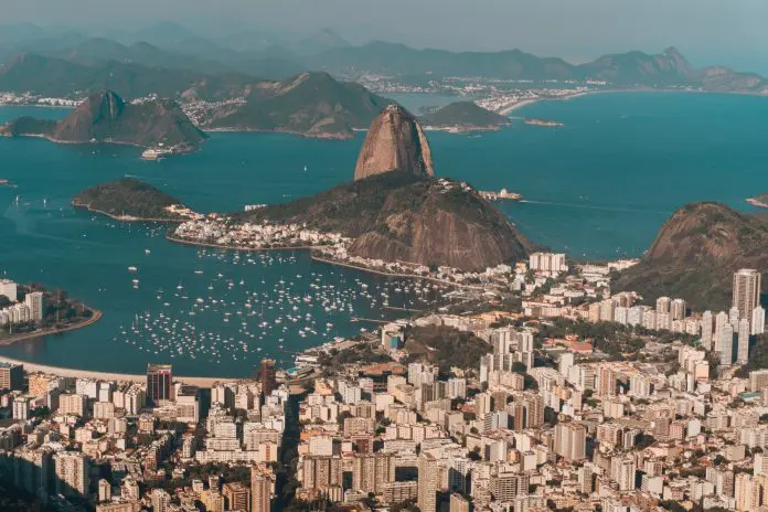 Aerial photo of Rio de Janeiro surrounded by the sea and hills under the sunlight in Brazil brasileiros booking